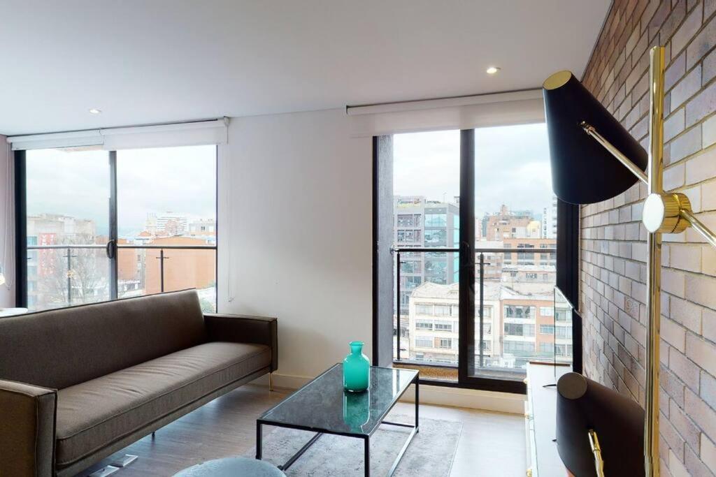 a living room with a couch and a table at 902 Cityscape Loft in Bogotá