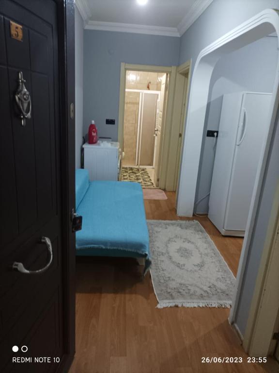 a room with a blue ottoman in front of a door at Goldwinn turizm in Trabzon