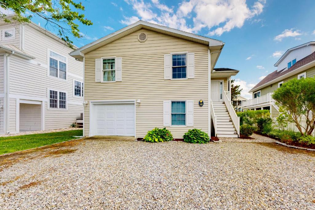 a white house with a garage at Town of South Bethany --- 142 Henlopen Drive in Bethany Beach