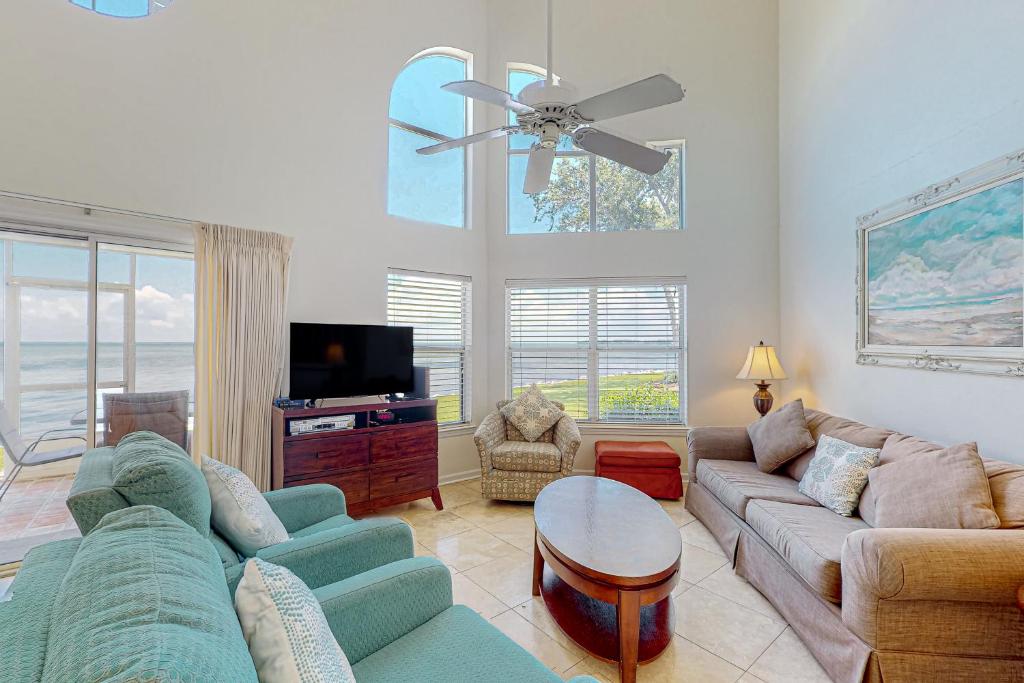 a living room with a couch and a tv at Waterfront Haven Retreat in Destin