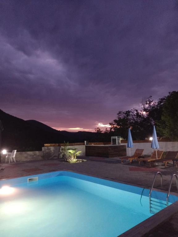 a swimming pool at night with a view at Vila Nikola 
