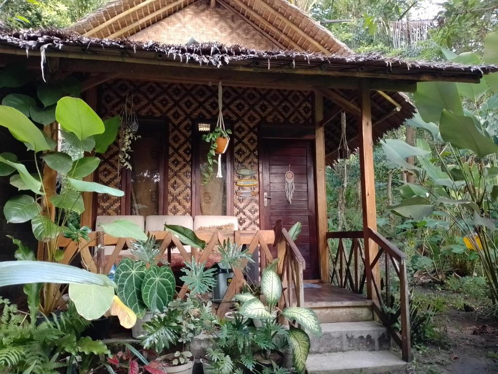 a small house in the jungle with plants at anik homestay & dormy Batukaras in Batukaras