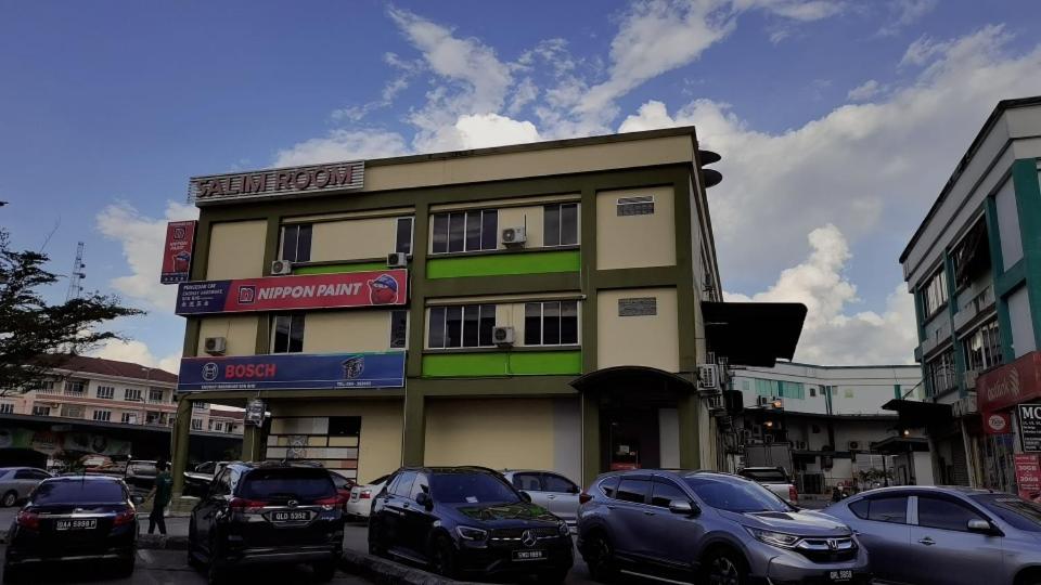 um edifício com carros estacionados em frente em Salim Room em Sibu