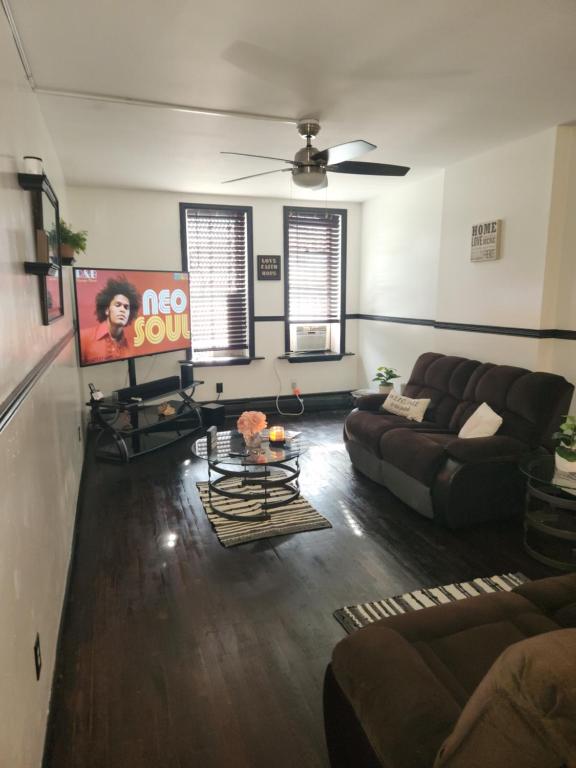 a living room with a couch and a table at Spacious 3br, 2b in Brooklyn