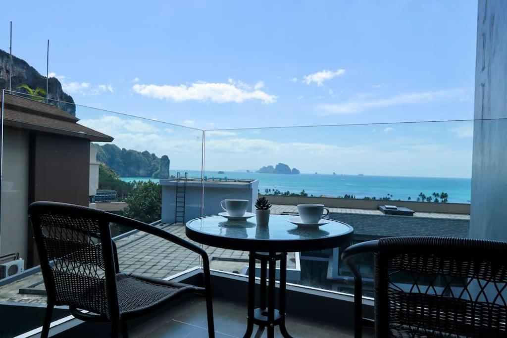 a table and chairs on a balcony with a view of the ocean at A401-Silk Condo Aonang, Sea view - 5 mins to beach in Krabi