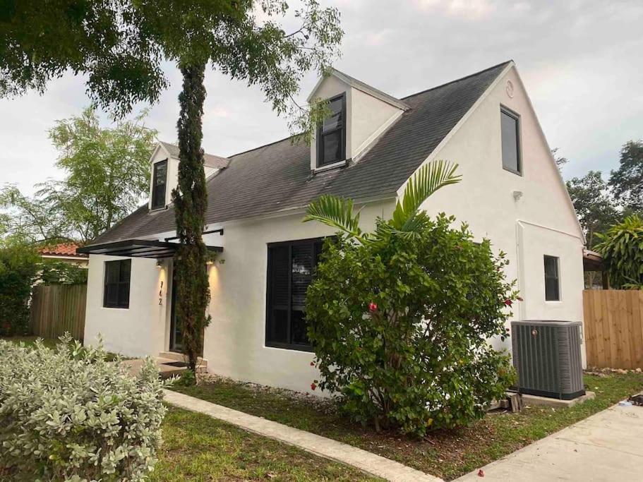 a white house with a black roof at Cozy Chalet near the Design District in Miami