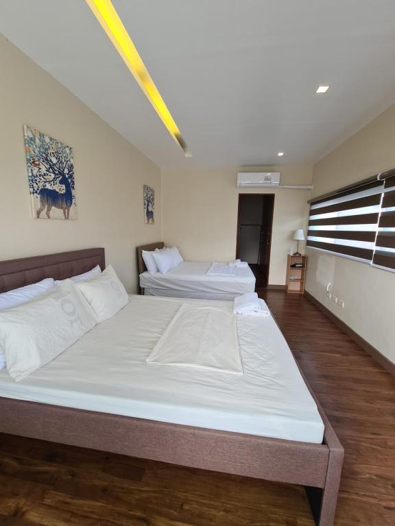 Postel nebo postele na pokoji v ubytování Serenity Home near Ayala Malls Serin
