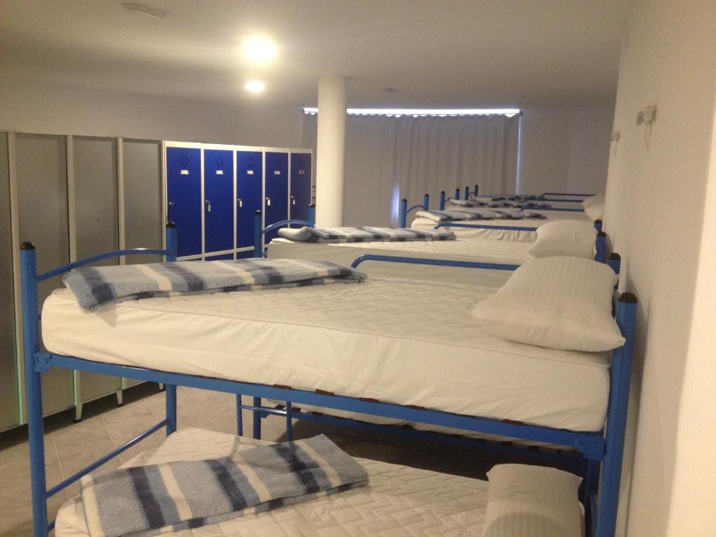 a row of bunk beds in a room at Albergue @ Muxia in Muxia