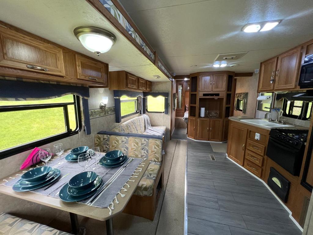 a dining room and kitchen in an rv at Salmon River RV camping in Mountain Grove