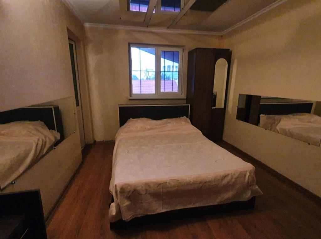 a bedroom with two beds and a window at Diana center Hotel with Grill zone and yard in Chişinău