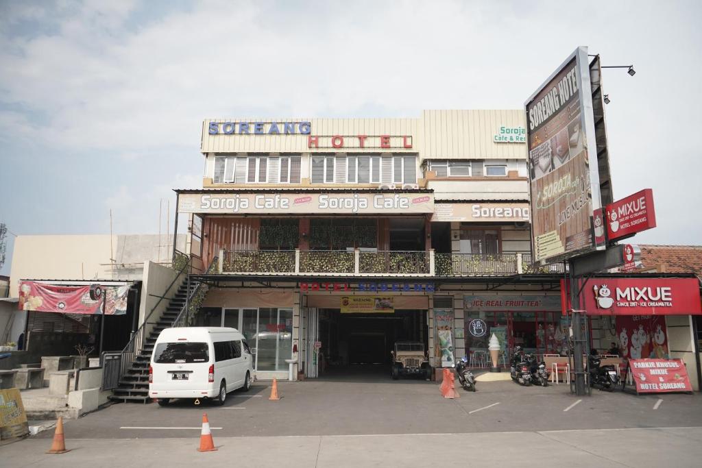 una furgoneta blanca estacionada frente a un edificio en Hotel Soreang en Bandung