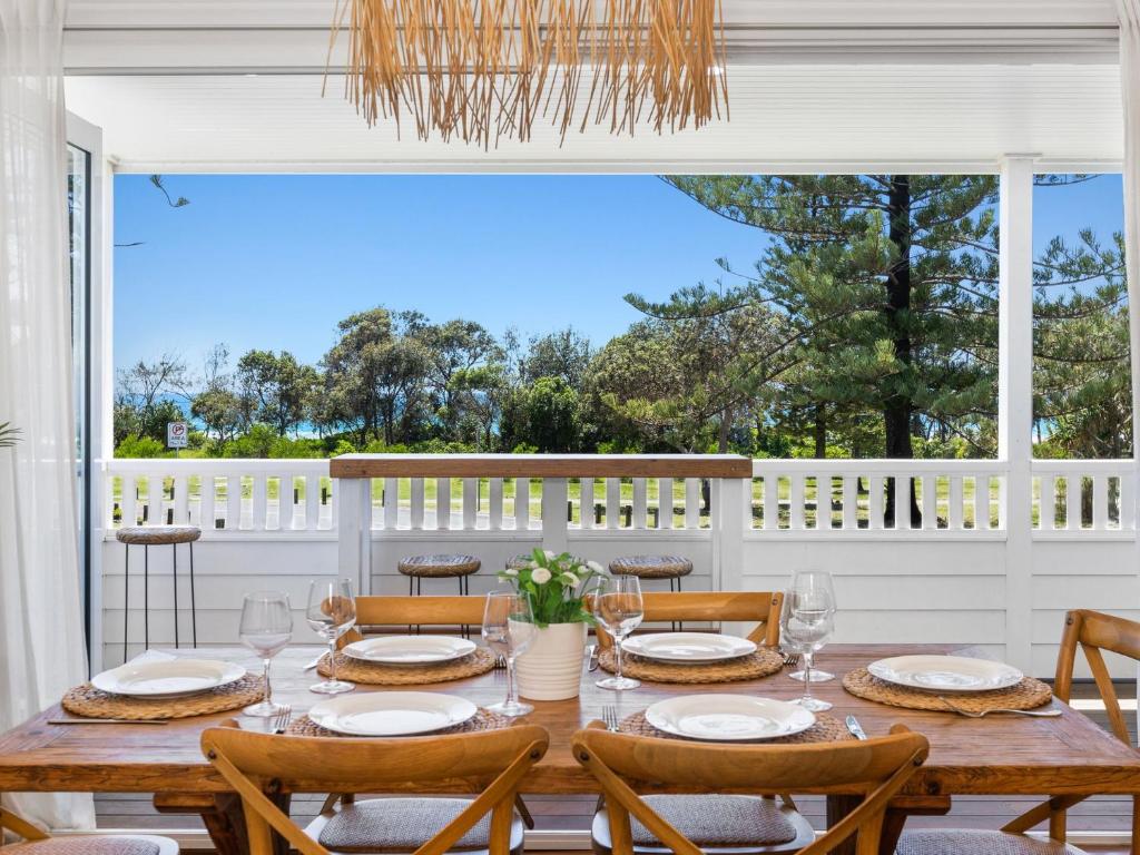 a dining room with a table and chairs at Oceanfront Beach House On Marine Parade in Kingscliff