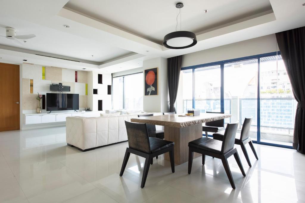 a living room with a table and chairs and a couch at M Estate Private Residence 3BR, Heart of Bangkok in Bangkok