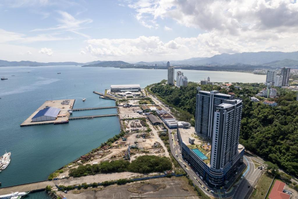 an aerial view of a city and a body of water at HayBay Jesselton Quay Deluxe Seaview Suite 海景观 in Kota Kinabalu