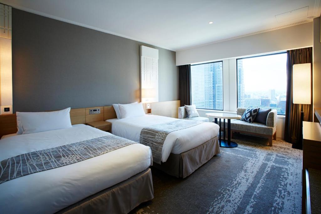 a hotel room with two beds and a window at Keio Plaza Hotel Tokyo in Tokyo