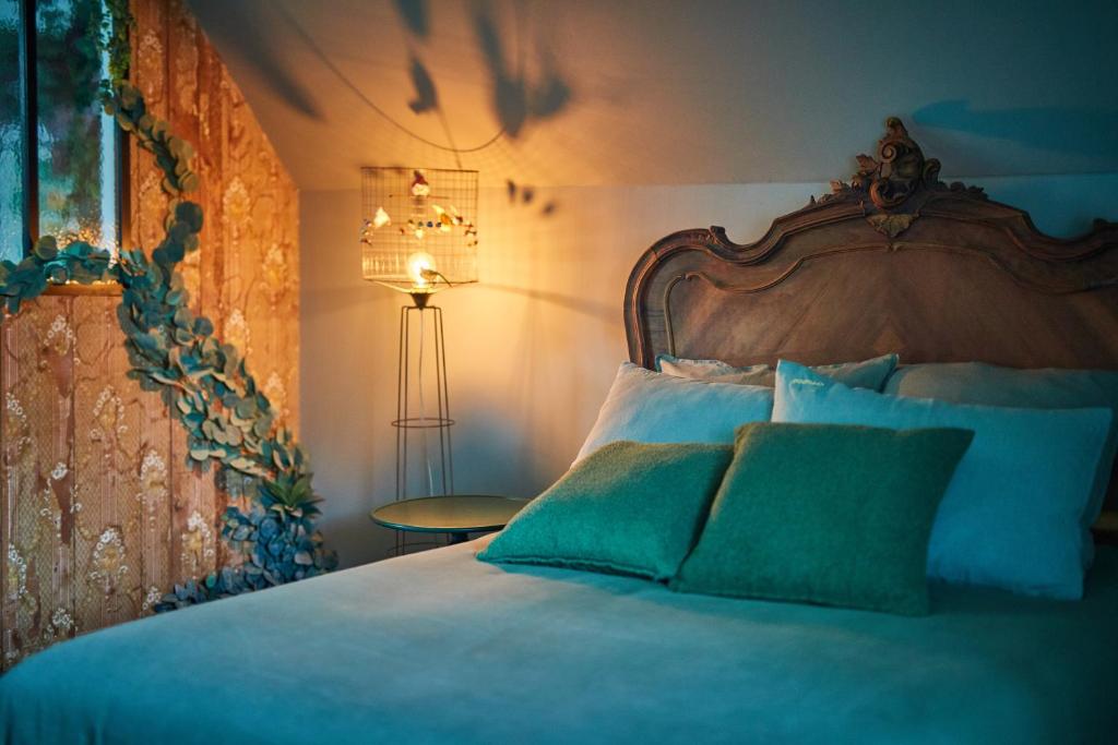a bedroom with a large bed with blue sheets and a lamp at la_grande_guerais in Beaussais sur Mer