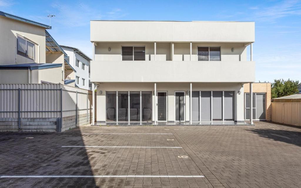a white building with a parking lot in front of it at No.8 - The Block in Victor Harbor