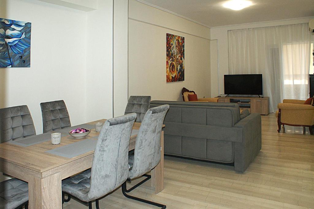 a living room with a table and a couch at Stylish & relaxing 70 sq. m. flat with balcony in Athens