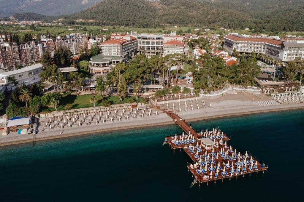 a group of people sitting on a dock in the water at Akra Kemer - Ultra All Inclusive in Kemer