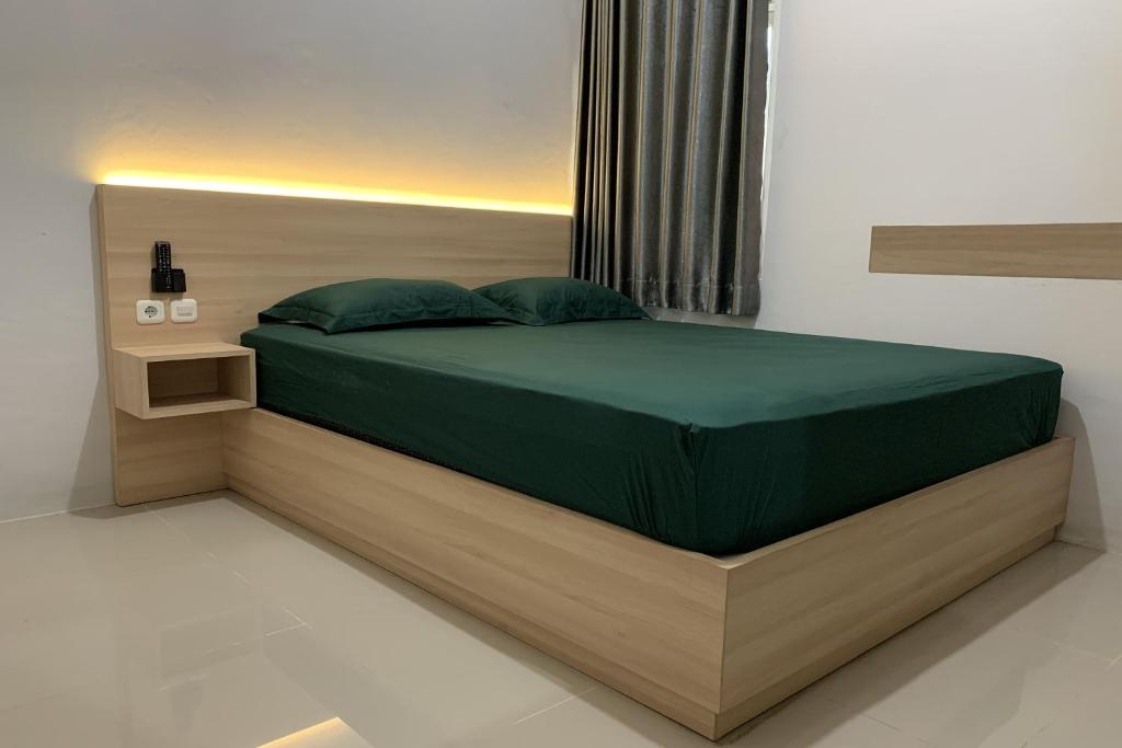 Postel nebo postele na pokoji v ubytování Hotel Merak Indah
