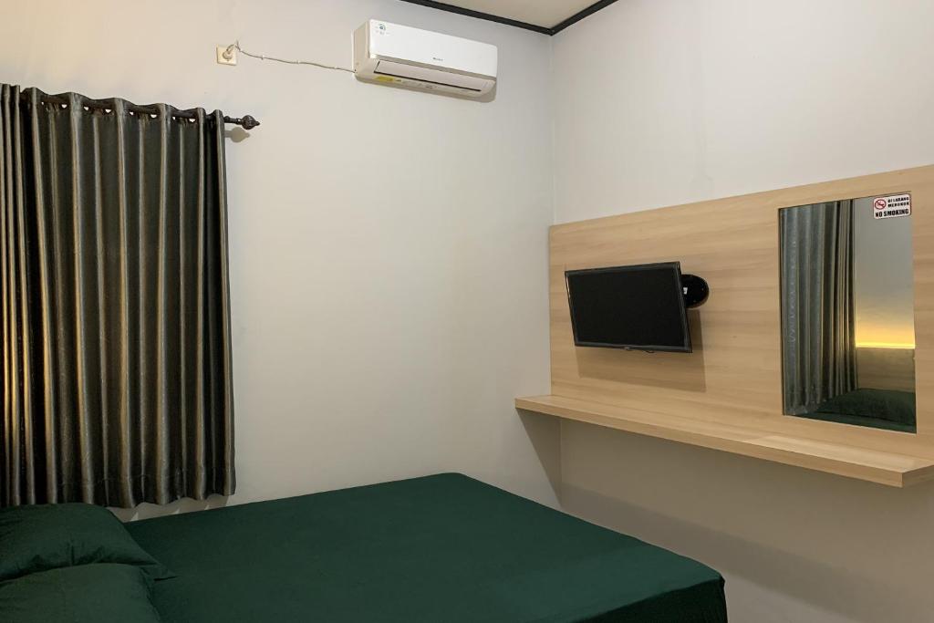 Postel nebo postele na pokoji v ubytování Hotel Merak Indah
