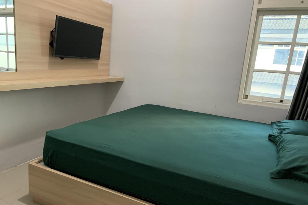 Postel nebo postele na pokoji v ubytování Hotel Merak Indah