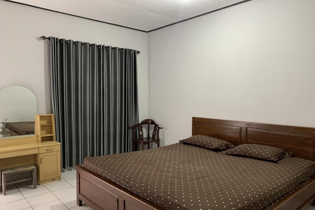 Postel nebo postele na pokoji v ubytování Hotel Merak Indah