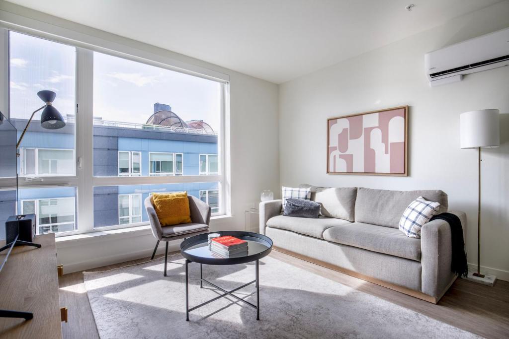 a living room with a couch and a table and a window at First Hill jr 1br w gym lounge bbq nr park SEA-580 in Seattle