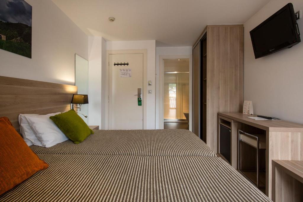 Postel nebo postele na pokoji v ubytování Hotel Del Pui