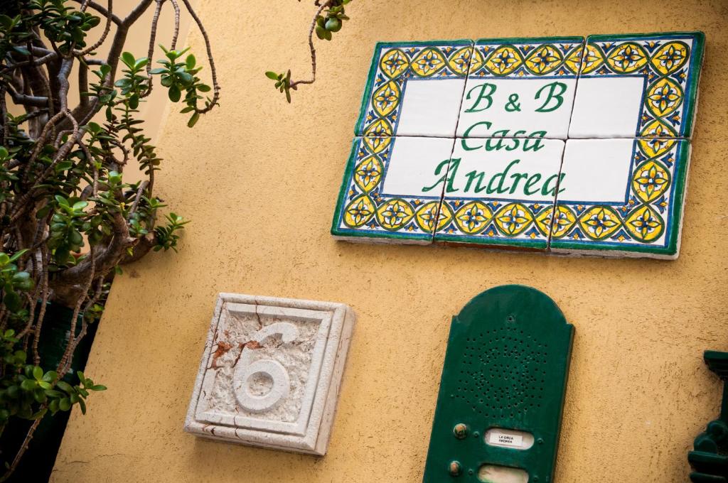 a sign on a wall with a skateboard on it at B&B Casa Andrea in Taormina
