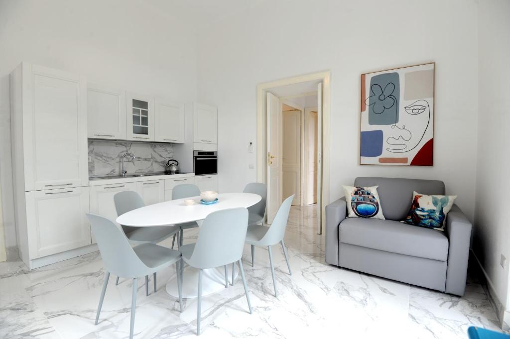 a kitchen and dining room with a table and chairs at Depandance Caramare in Cala Gonone