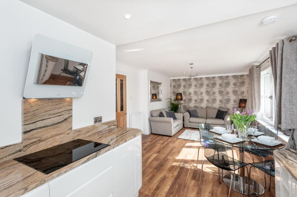 a living room with a table and a couch at Gilmour's Entry Apartment in Edinburgh