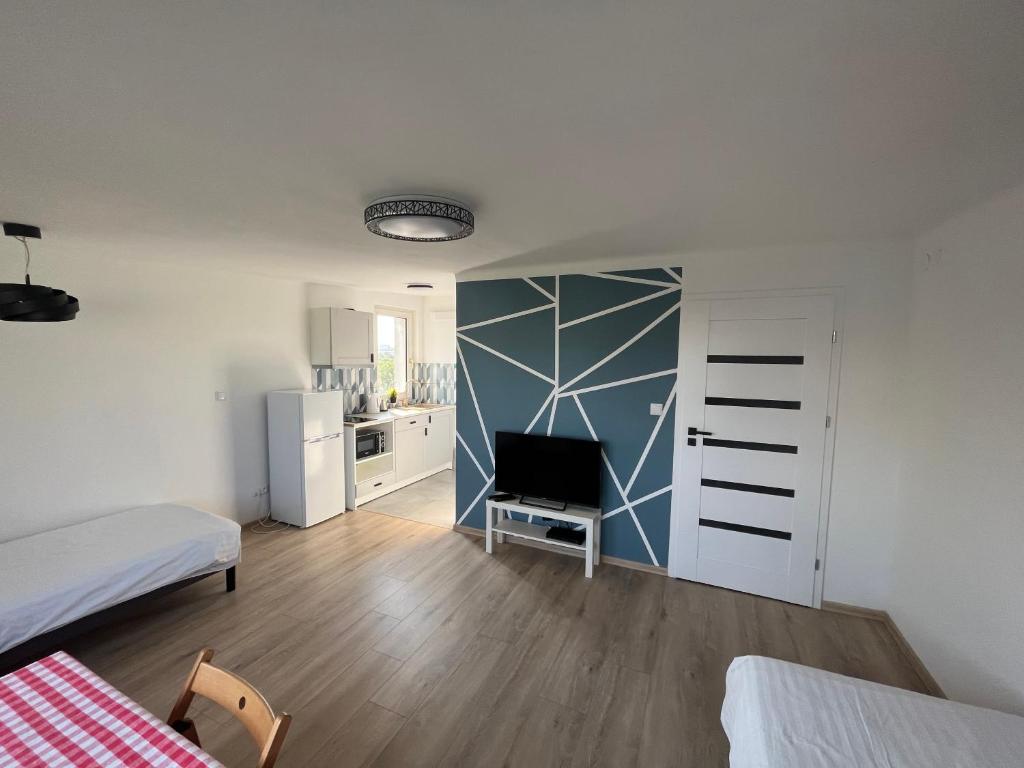 a living room with a bed and a tv in it at Murano Apartaments City Center Duo in Warsaw