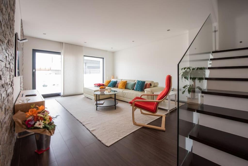 a living room with a couch and a red chair at Casa da Perafita /Matosinhos, 2 Km from the beach in Perafita