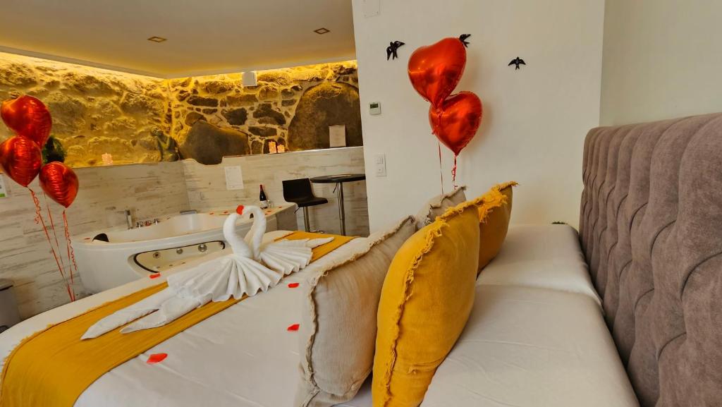 a bedroom with red hearts and a bed with balloons at Loft con Jacuzzi os Arcos in Sober