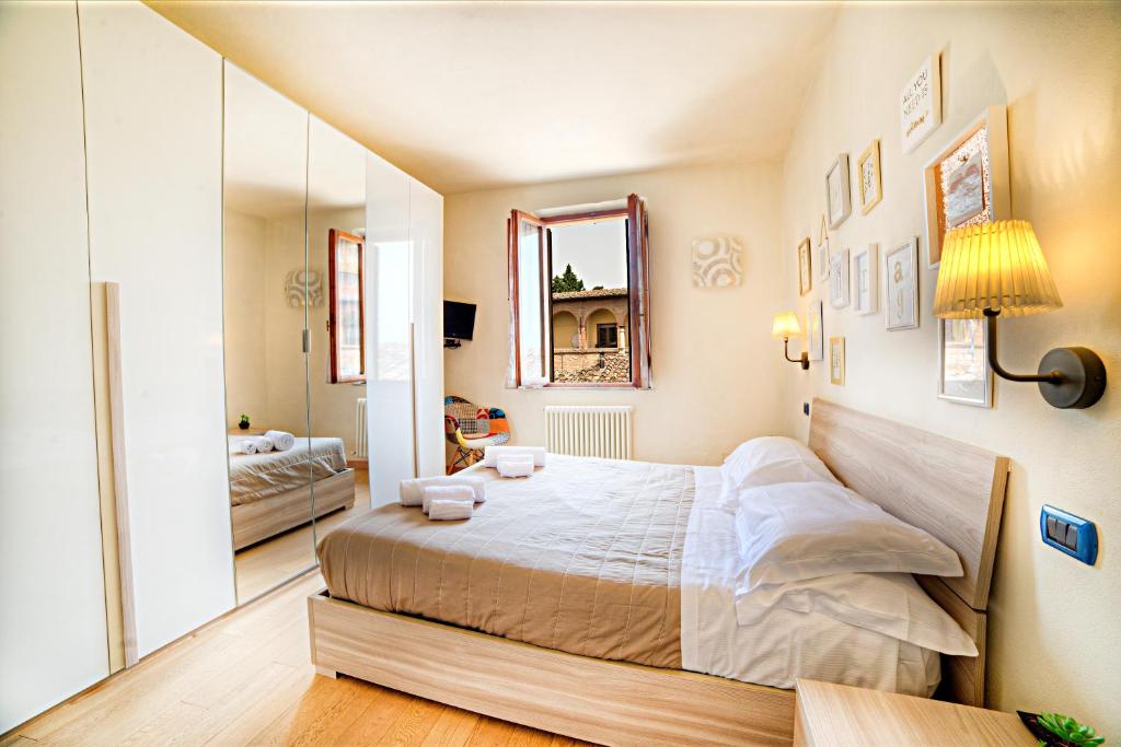 シエナにあるNicchio Bright And Design Loftのベッドルーム(大型ベッド1台、鏡付)
