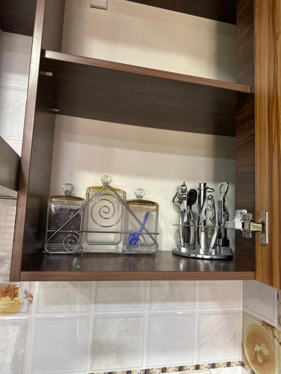 a shelf with various items on it in a kitchen at Darhan in Tashkent