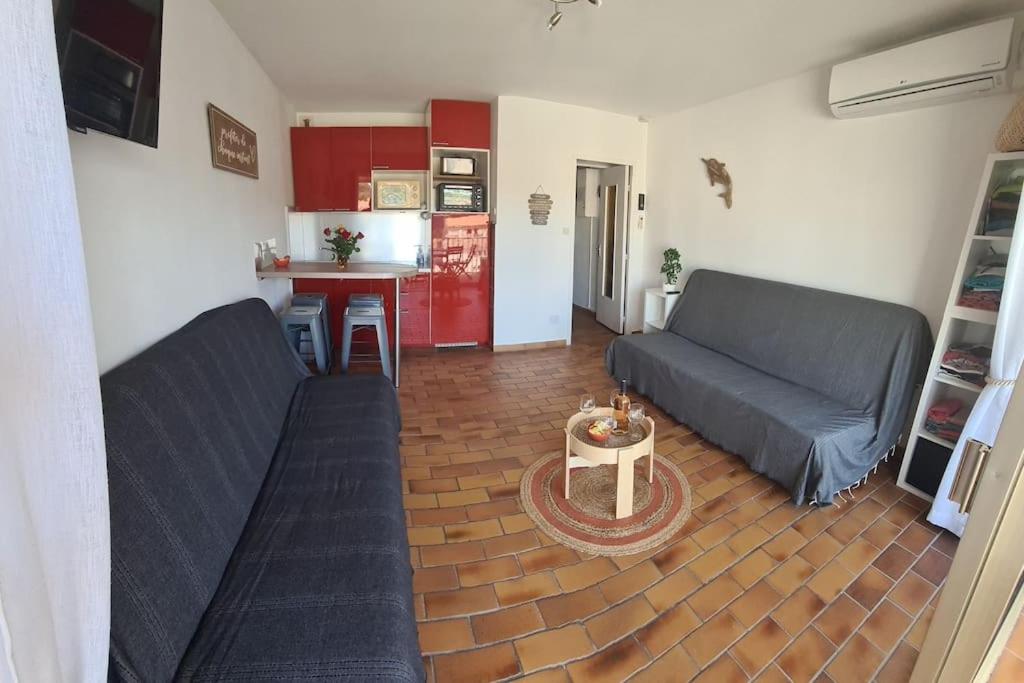 a living room with two couches and a kitchen at COSY Studio Wifi Clim Terrasse parking in Six-Fours-les-Plages