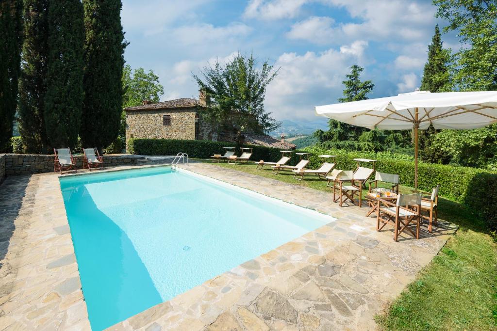 une piscine avec des chaises et un parasol dans l'établissement Crognole 6, Emma Villas, à Radda in Chianti