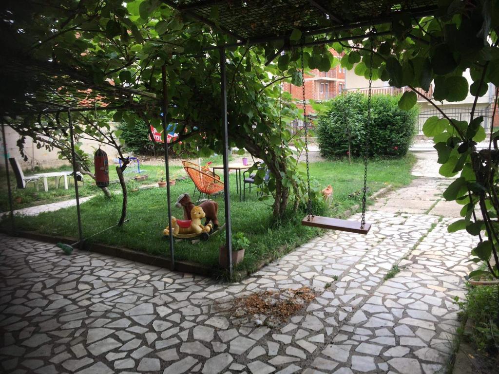 a park with a toy dog sitting in a swing at Rooms Struga in Struga