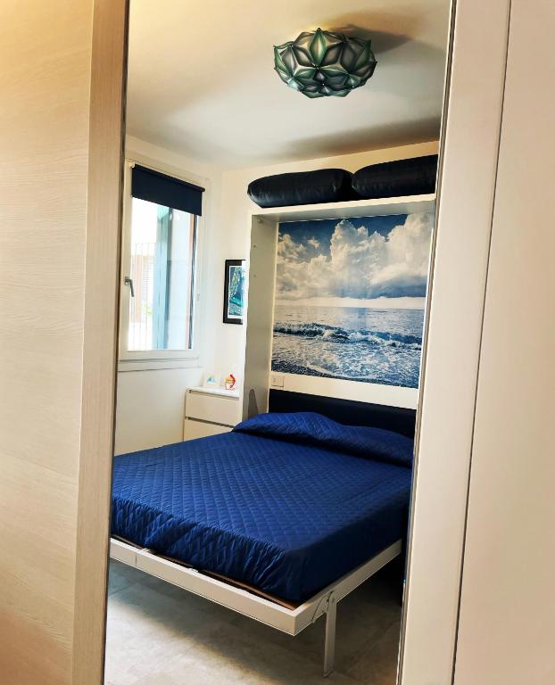 a bedroom with a bunk bed with blue sheets at Le Vele Luxury Mini Apartment in Chioggia