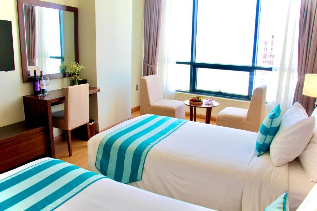 Postel nebo postele na pokoji v ubytování Avatar Danang Hotel