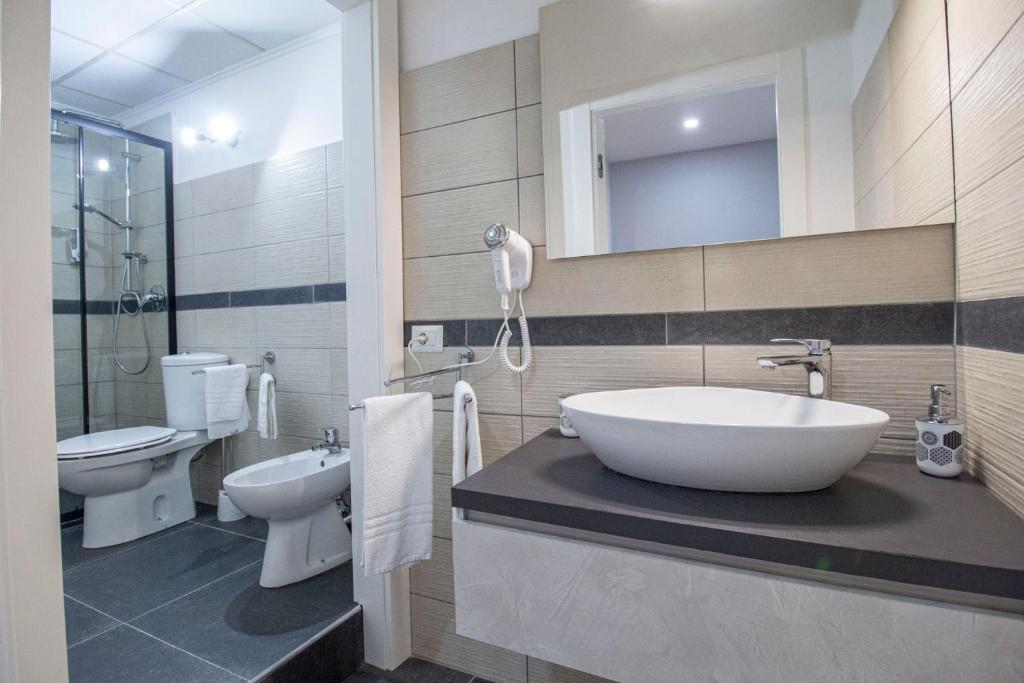 a bathroom with a tub and a sink and a toilet at Royal Playa Suite and Apartament -private parking- self chek out in Catania