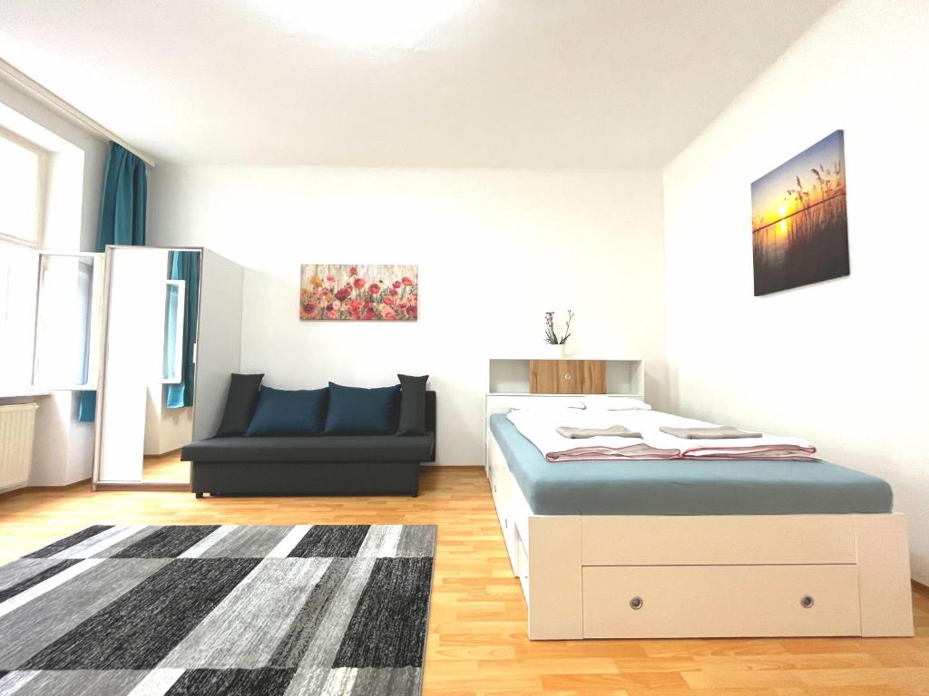 a bedroom with a bed and a couch at 7brunnen Hostel Beds & Rooms in Vienna