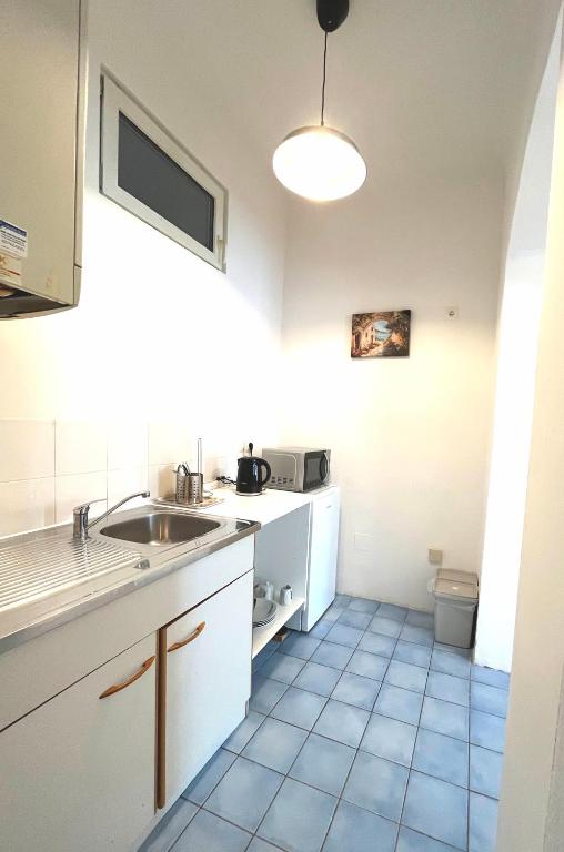 a kitchen with a sink and a toilet in it at 7brunnen Hostel Beds & Rooms in Vienna