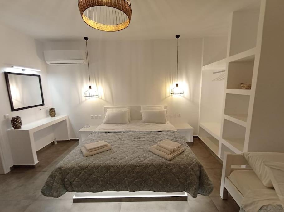 a bedroom with a bed with two towels on it at sea melody tinos 2 in Agios Sostis