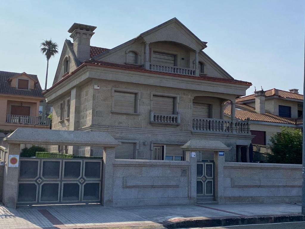 a large stone house with a large garage at PLAYA AMERICA MAR in Nigrán