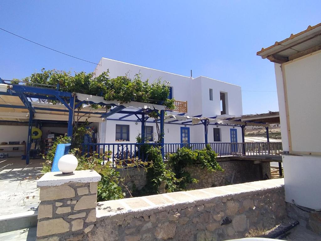 a white building with plants on the side of it at Central New Fully Furnished Apartments in Karpathos,Lefkos in Lefkos Karpathou