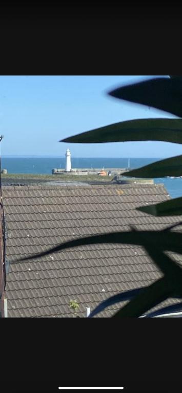 a roof with a light house and a lighthouse at Sea View Terrace in Donaghadee