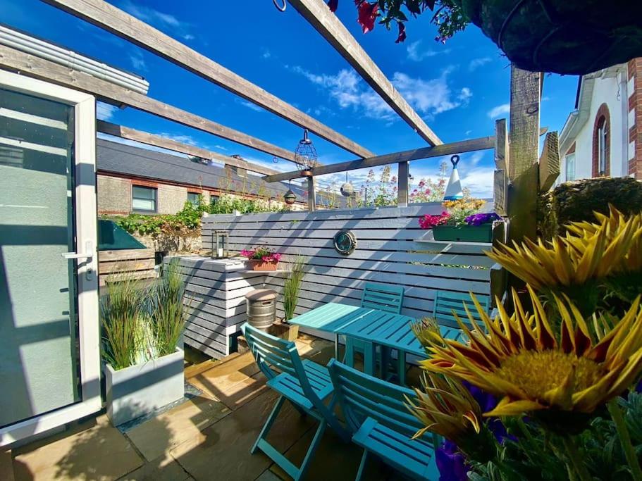 a patio with a blue bench and some plants at Cosy Retreat in The City Centre in Galway
